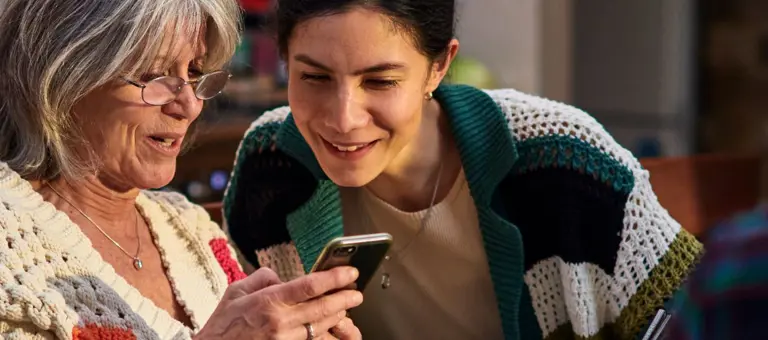 Two women looking at a mobile phone