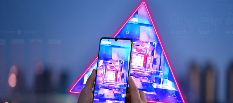 Hand holding a smartphone in front of data graphs