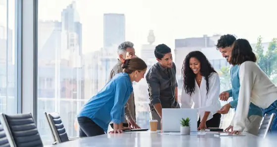 Group of people smiling mid meeting in a high rise building
