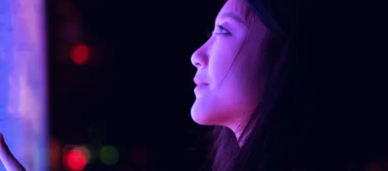 Woman looking at a purple screen