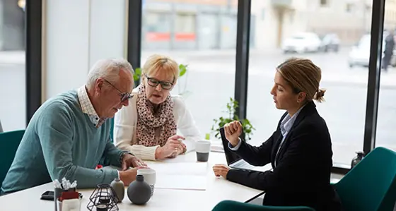 Middle aged couple going through a contract with an insurer