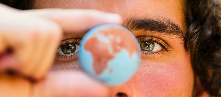 Close up view of a man holding a globe