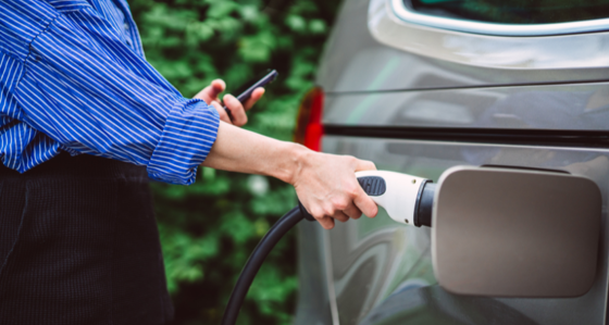 Woman charging an electric car