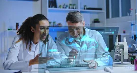 Two people in front of screen