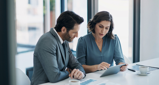 Two business people analysing data