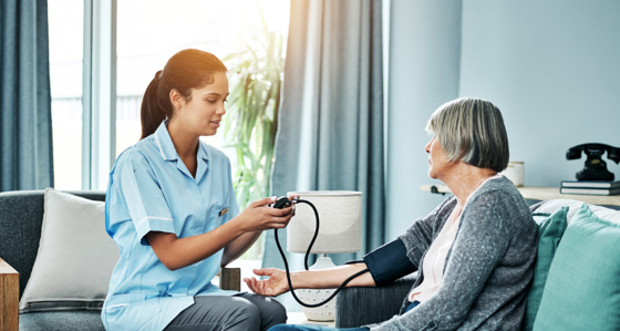Home nurse checking a patient's blood pressure