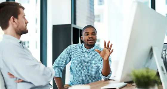 Two people looking at a computer