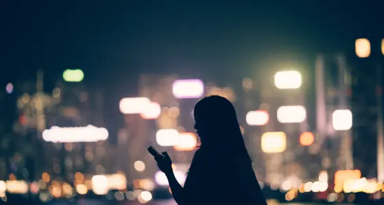 Woman looking at her phone in the city