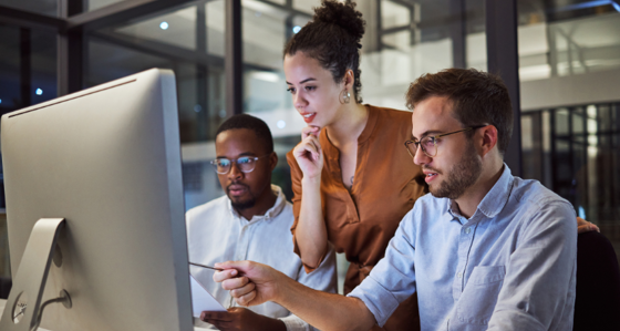People in an office looking at a screen