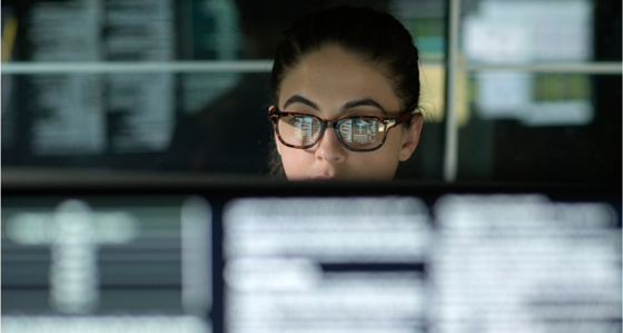 Woman working behind a screen in an office