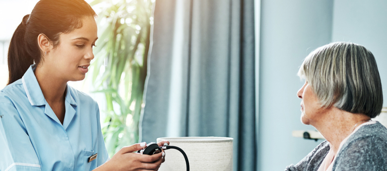 Home nurse checking a patient's blood pressure