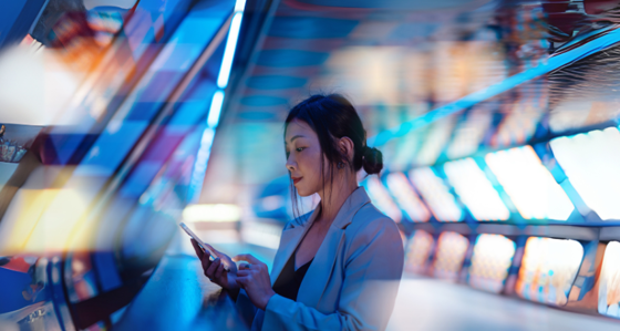 Young Asian business woman using smart phone in a Virtual Reality (VR) environment