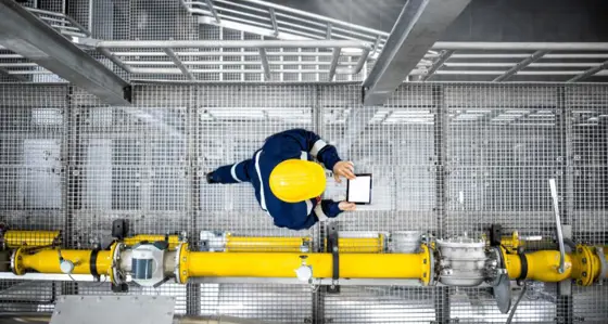 Worker walking on a metallic footbridge