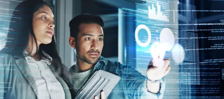 Two people reviewing information on a screen