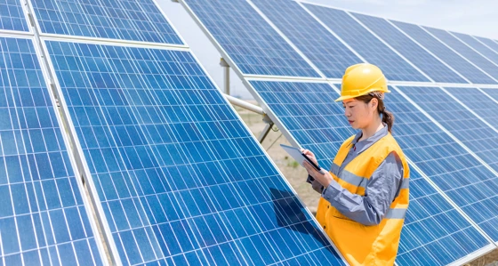 Woman working on solar panels