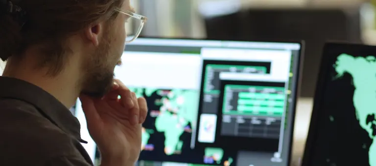 A man viewing a world map on a screen