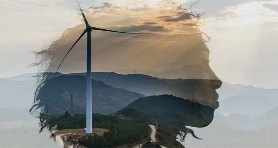 A woman's head superimposed over a hillside with a wind turbine