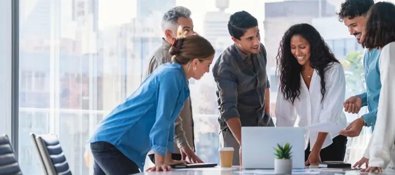 Group of people smiling mid meeting in a high rise building