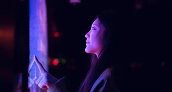 Woman looking at a purple screen