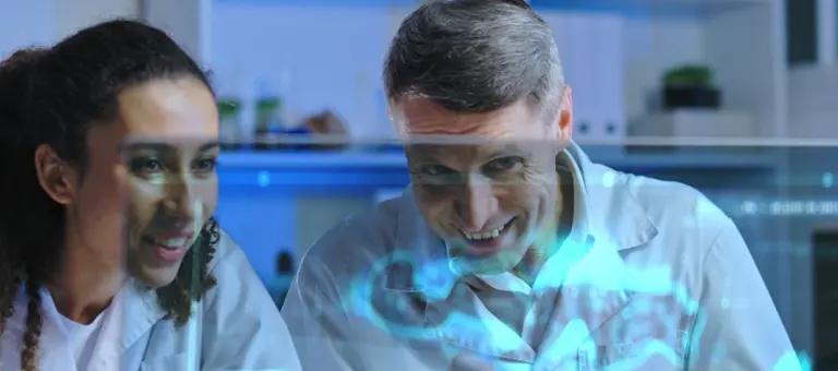 Two people in front of screen