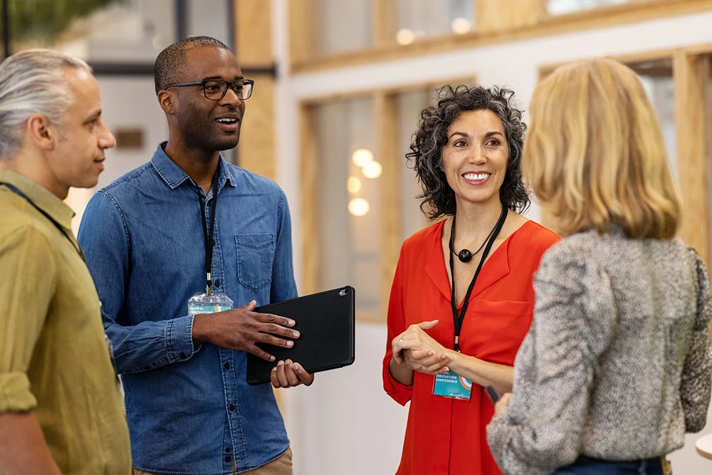 Group of businesspeople discussing on the edges of a start up conference