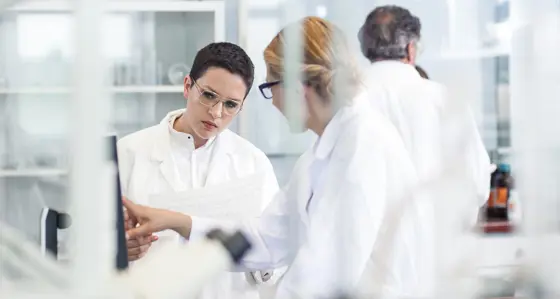 Two laboratory technicians discussing results