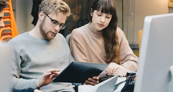 Three colleagues looking at a tablet