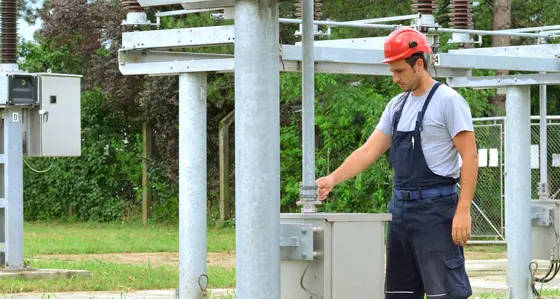 An engineer inspecting equipment in an electrical substation