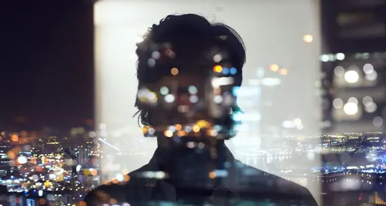 Silhouette of business man against city
