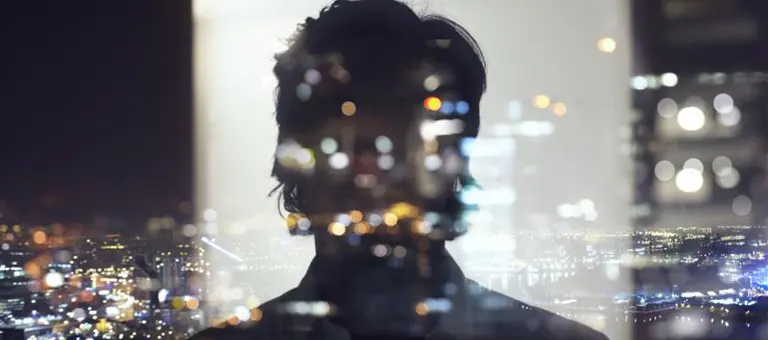 Silhouette of business man against city