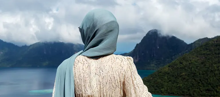 Woman Looking Over Beautiful View of an Ocean in Bohey Dulang
