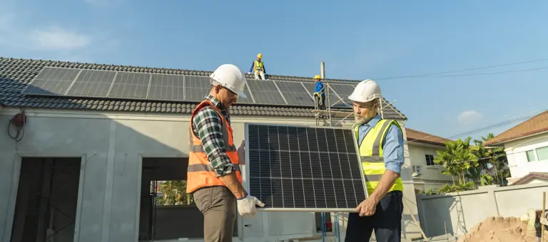 Two engineers installing a solar panel