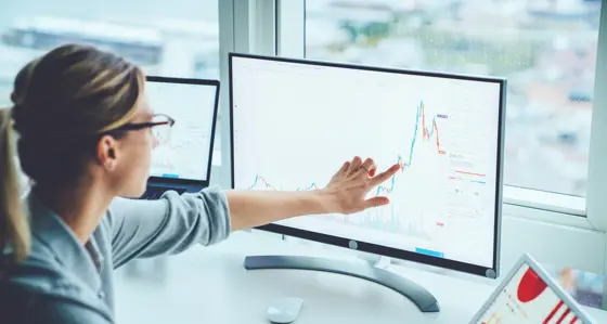 Woman pointing at chart on screen