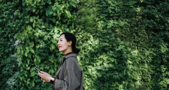 Business woman in front of trees